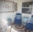 SCREEENED LANAI WITH A PADDED WOODEN ROCKER & TWO PADDED RECLINER CHAIRS