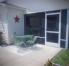 SCREEENED LANAI WITH A PADDED WOODEN ROCKER & TWO PADDED RECLINER CHAIRS