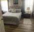 Primary bedroom, queen bed with electric frame.  New wooden floors.