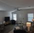 Living space with smart TV, blankets, games, and puzzles in the tv cabinet